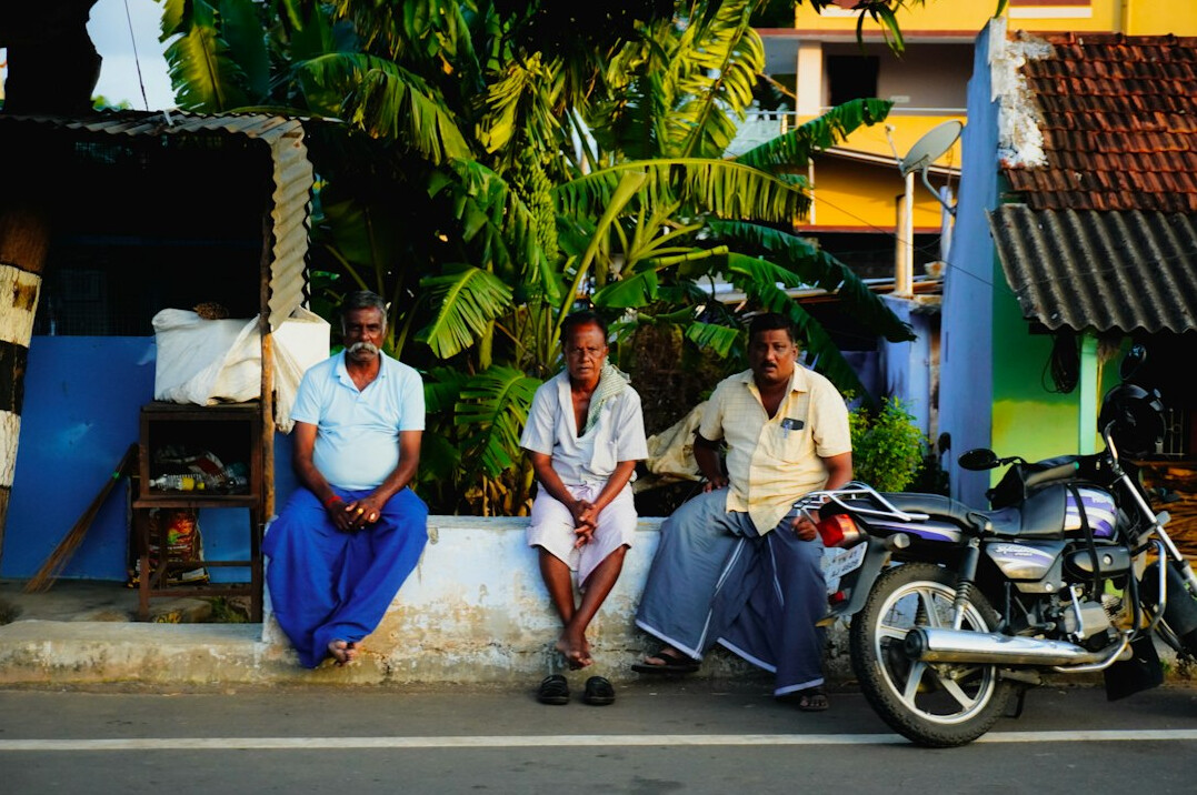 elderly men talking in village